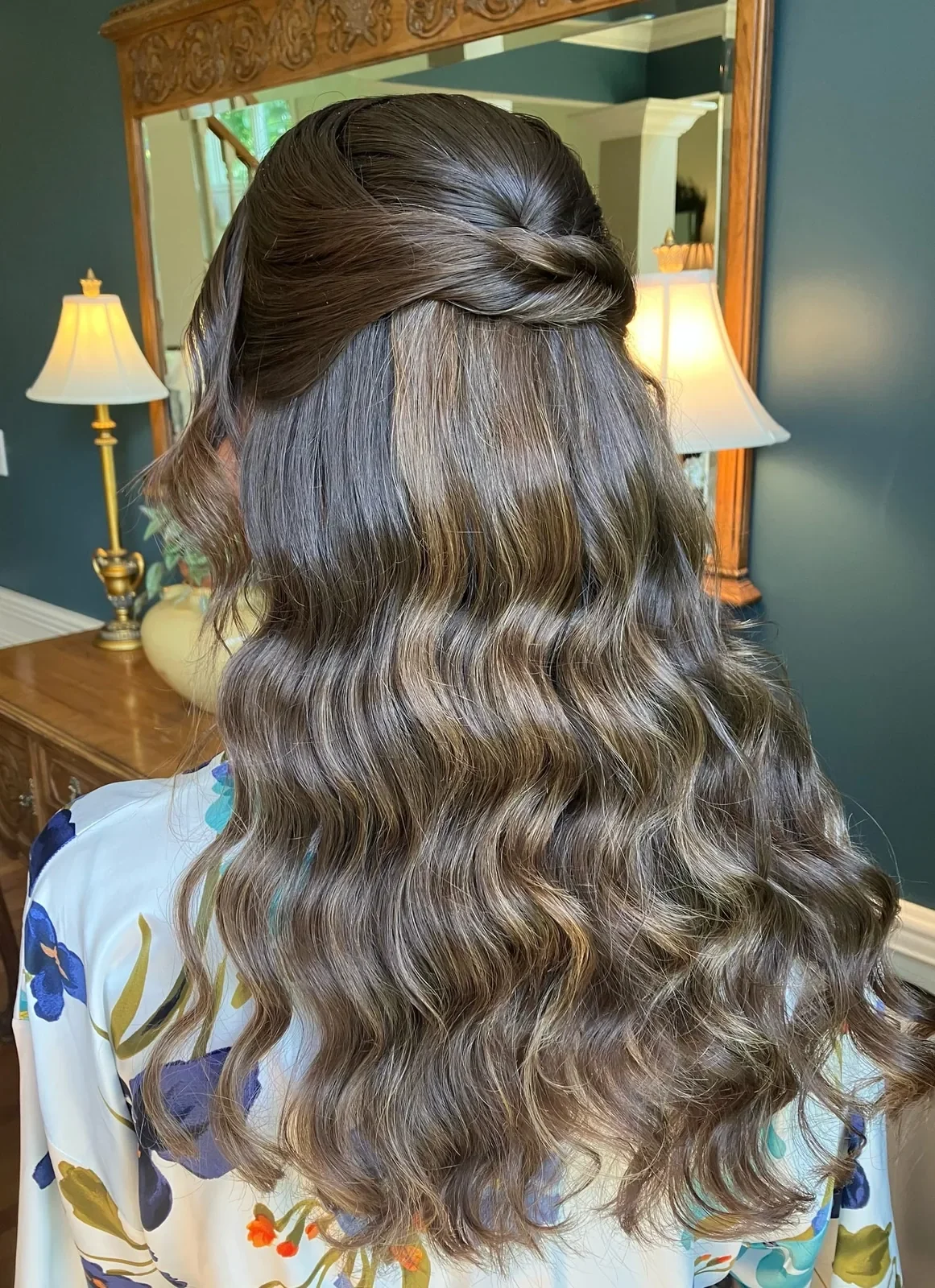 Back view of brunette twisted half-up hair with long waves