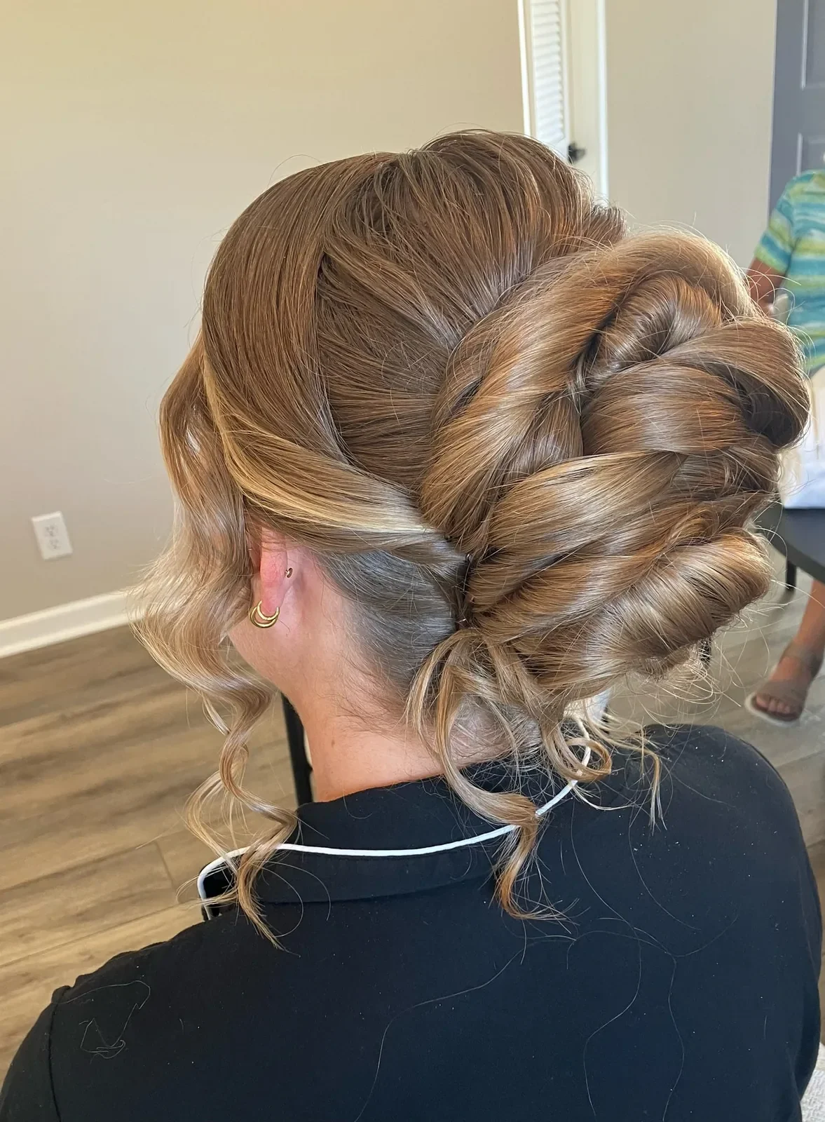 Blonde bridesmaid with a braided low updo