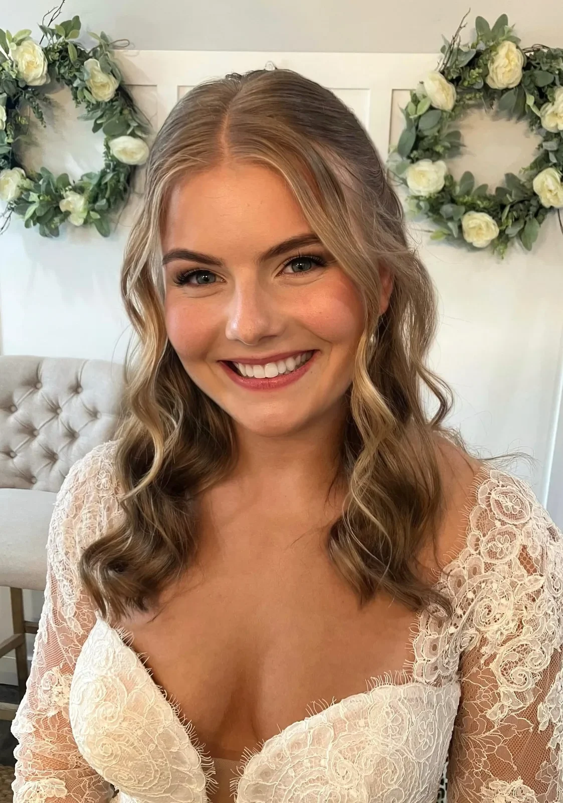 Blonde bride with half-up waves and soft-glam wedding makeup