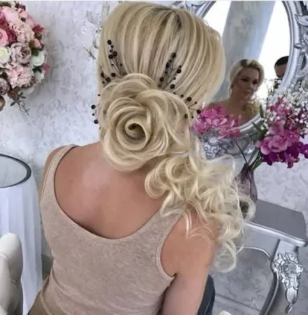 Blonde bridal rosette updo with cascading curls and decorative pins by Glow Salon & Spa in Carmel, Indiana
