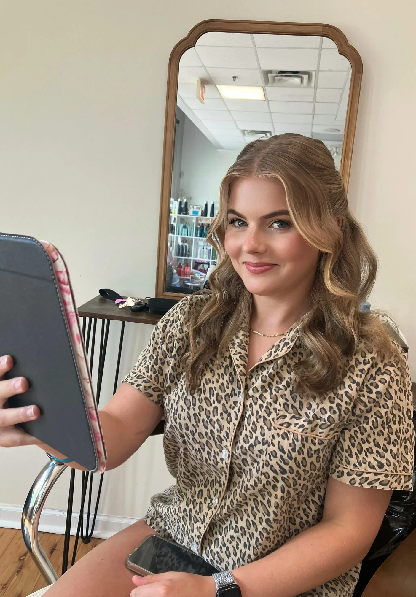 Blonde half-up bridal hairstyle with polished waves and soft-glam makeup by Glow Salon & Spa
