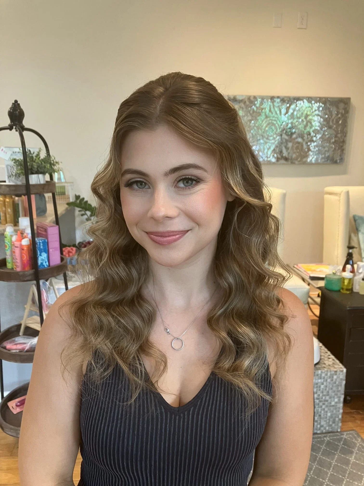 Portrait of a blonde bridal party guest with half-up soft waves and natural makeup