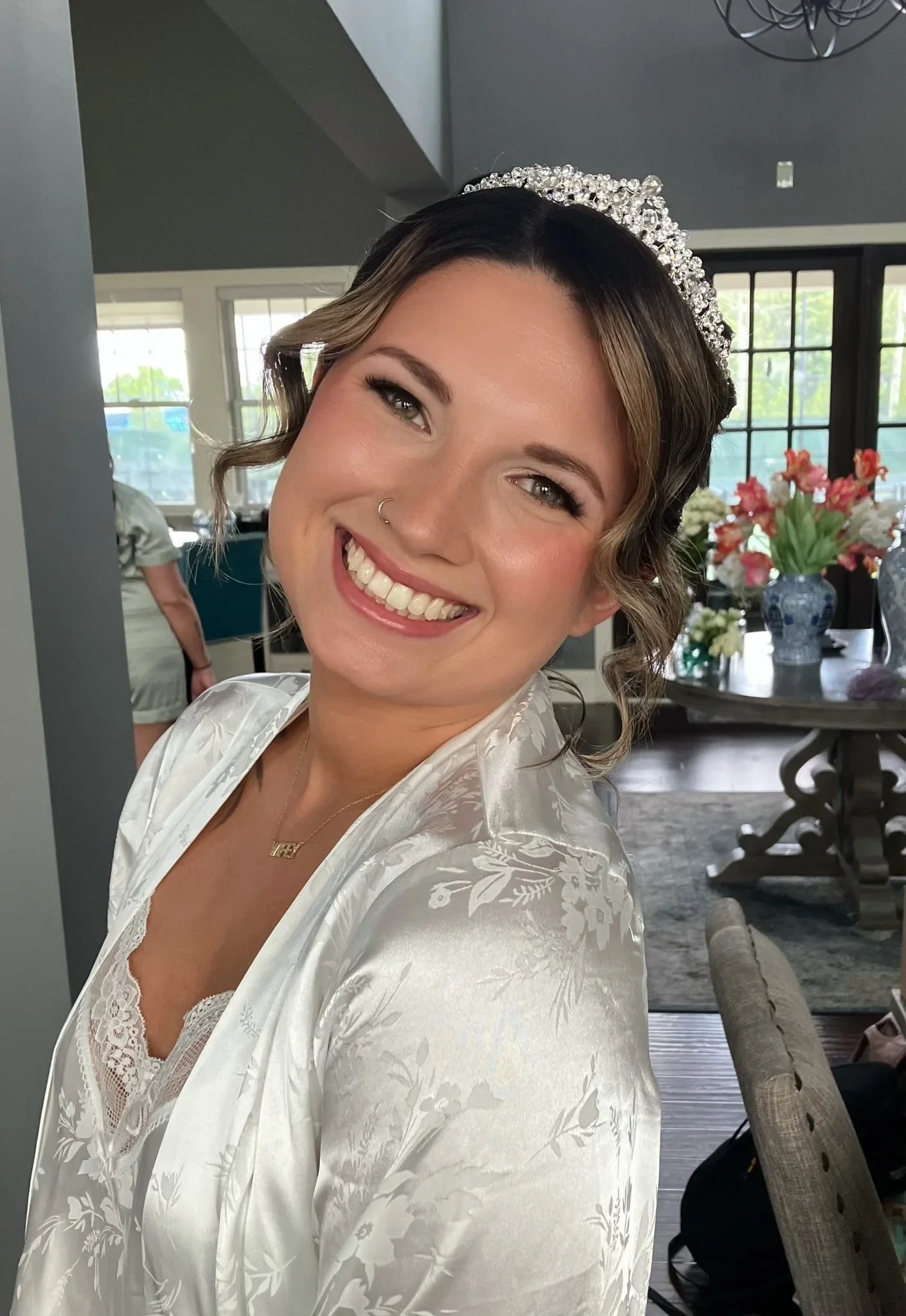 Bride with tiara, elegant updo, and soft-glam wedding makeup by Glow Salon & Spa in Carmel, Indiana