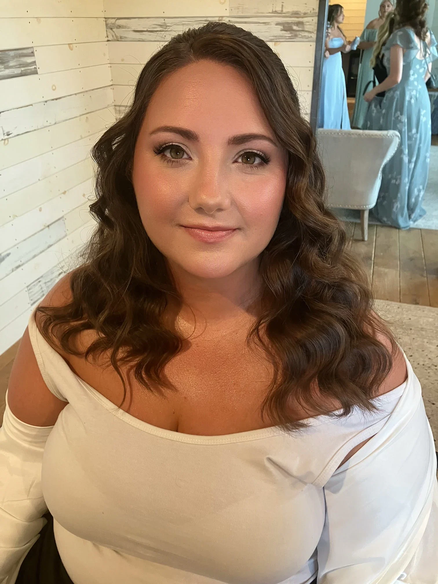 Brunette bride with polished waves and natural soft-glam wedding makeup by Glow Salon & Spa