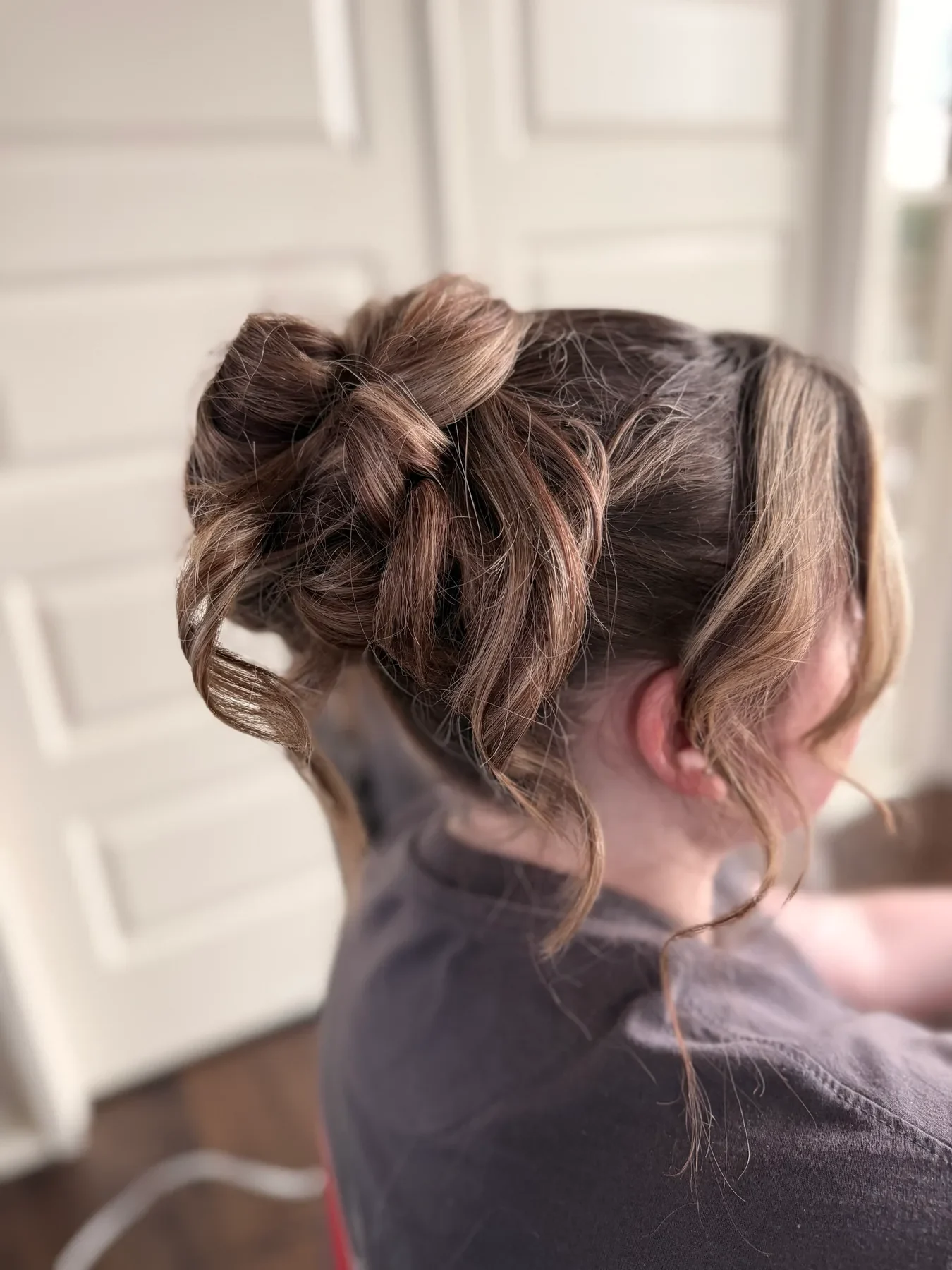 Textured brunette wedding updo with soft face-framing pieces