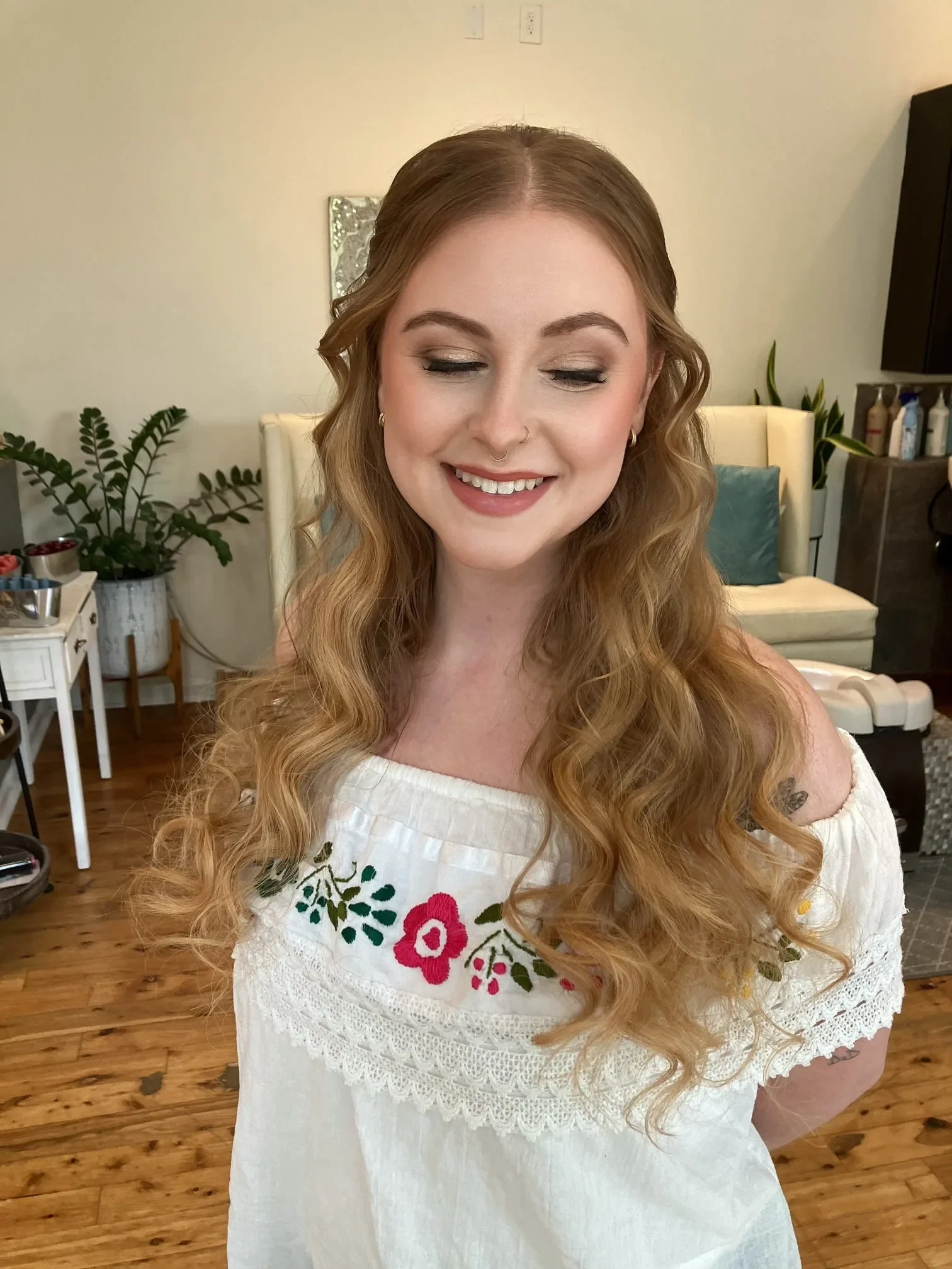 Strawberry blonde bride with half-up waves and soft-glam wedding makeup by Glow Salon & Spa